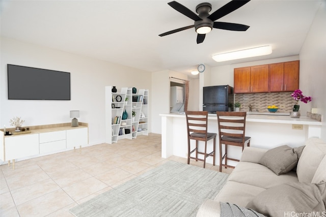 living room with ceiling fan and light tile patterned floors