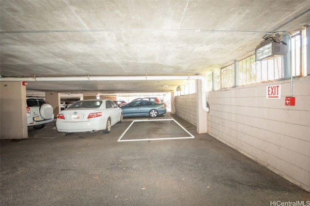 parking deck featuring concrete block wall