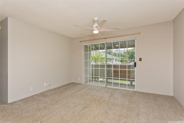 carpeted spare room featuring a ceiling fan and a textured ceiling