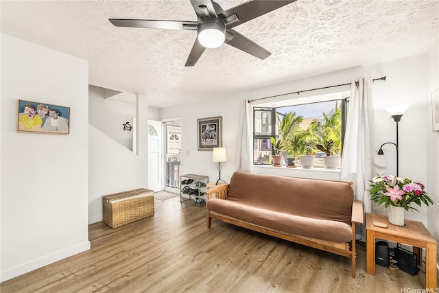 68-037 Apuhihi St Unit B, Waialua, HI 96791 - sitting room featuring a textured ceiling, light wood finished floors, a ceiling fan, and baseboards