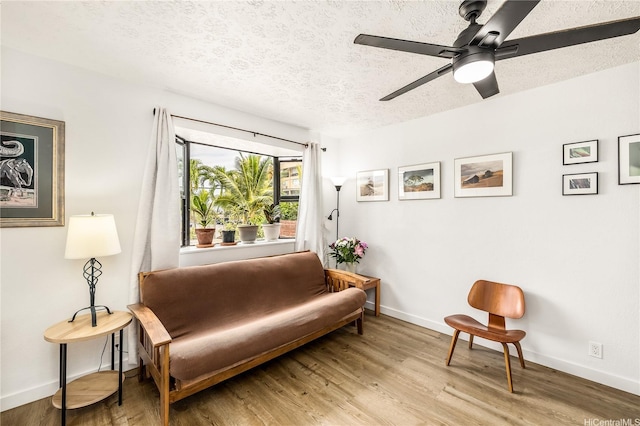 68-037 Apuhihi St Unit B, Waialua, HI 96791 - living area with light wood-type flooring, a textured ceiling, and baseboards