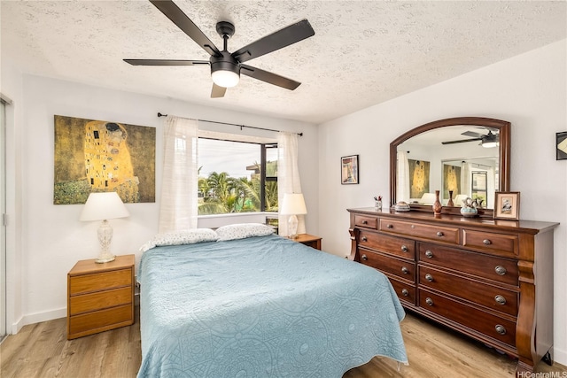 68-037 Apuhihi St Unit B, Waialua, HI 96791 - bedroom featuring a textured ceiling, light wood-style flooring, ceiling fan, and baseboards