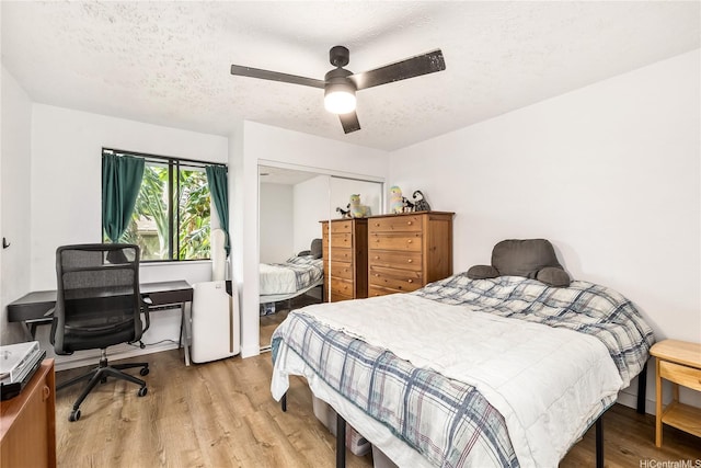 68-037 Apuhihi St Unit B, Waialua, HI 96791 - bedroom featuring wood finished floors, a closet, a textured ceiling, ceiling fan, and an office area