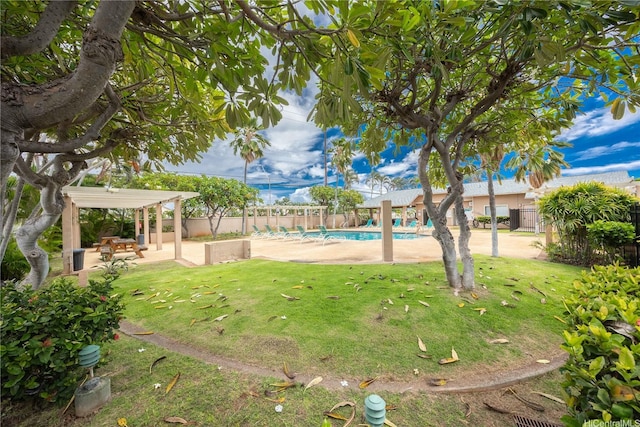 view of yard featuring a patio area, fence, and a fenced in pool
