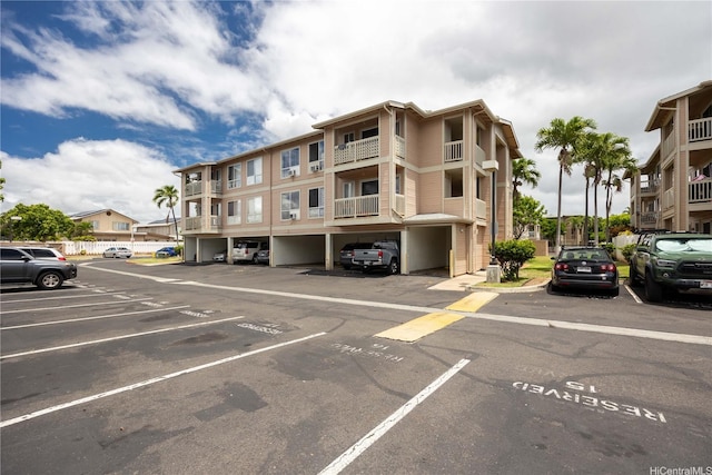 view of property with covered and uncovered parking