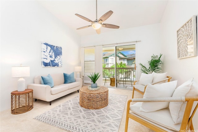 carpeted living area featuring ceiling fan and lofted ceiling