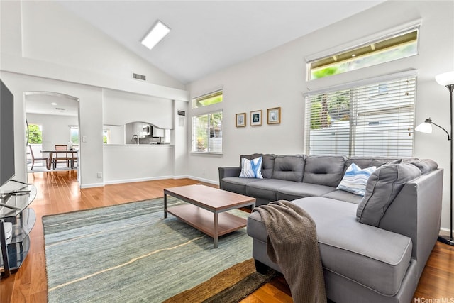 1000 Kaolo St, Honolulu, HI 96825 - living room featuring arched walkways, wood finished floors, and high vaulted ceiling