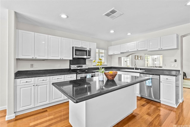 1000 Kaolo St, Honolulu, HI 96825 - kitchen with stainless steel appliances, white cabinets, light wood finished floors, recessed lighting, and a kitchen island