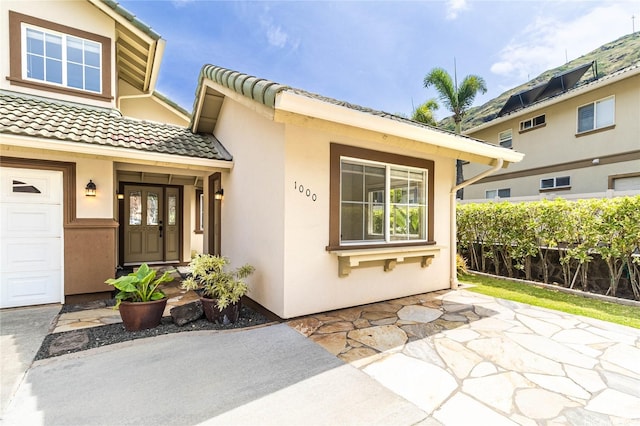 1000 Kaolo St, Honolulu, HI 96825 - property entrance with stucco siding and a tiled roof