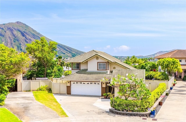 1000 Kaolo St, Honolulu, HI 96825 - traditional-style home featuring a mountain view, stucco siding, driveway, and fence