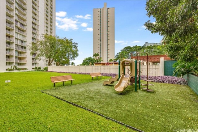 community playground with fence and a yard