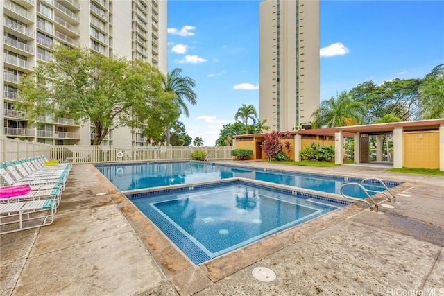 pool featuring a hot tub, fence, and a patio area