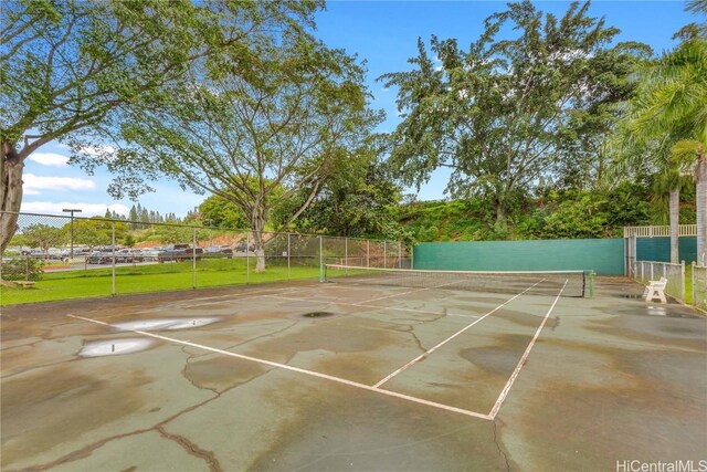 view of sport court featuring fence