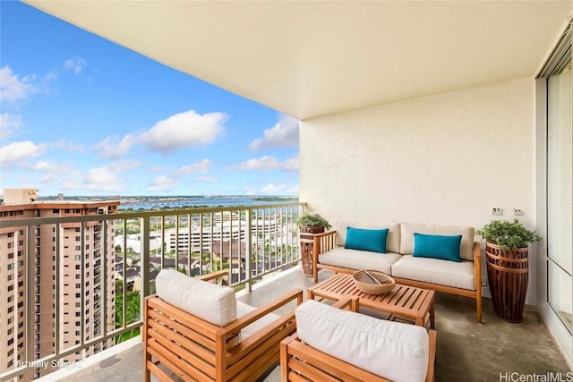 balcony with an outdoor hangout area and a water view