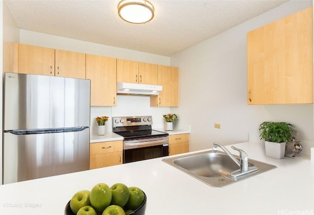 kitchen featuring a sink, light brown cabinets, appliances with stainless steel finishes, and under cabinet range hood