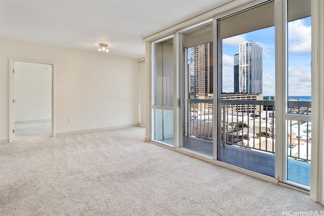 spare room featuring carpet floors, plenty of natural light, and a city view