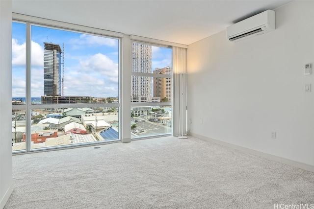 carpeted empty room with a wall mounted AC, baseboards, expansive windows, and a city view