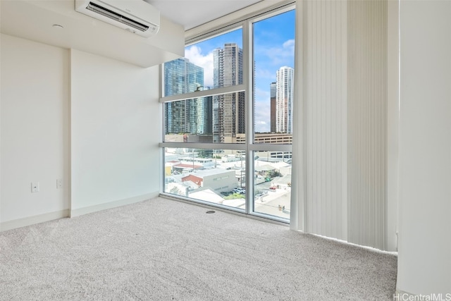 carpeted spare room featuring plenty of natural light, a wall mounted air conditioner, expansive windows, and a city view