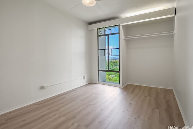 1511 Nuuanu Ave Unit 922, Honolulu, HI 96817 - unfurnished bedroom with baseboards, wood finished floors, and a ceiling fan