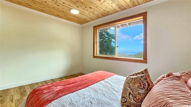 bedroom with baseboards, crown molding, wood finished floors, and wood ceiling