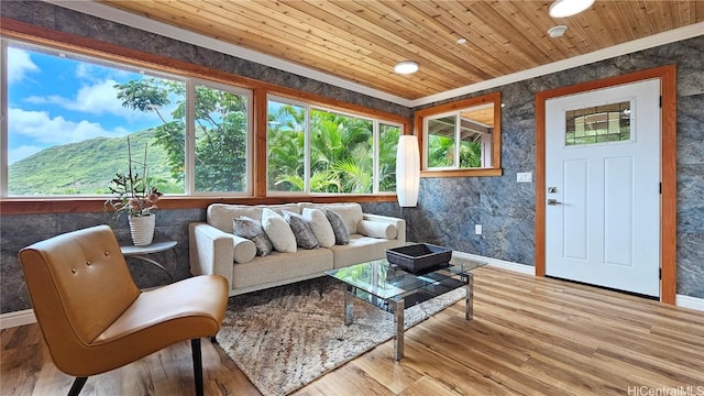 living room featuring wooden ceiling, baseboards, and wood finished floors