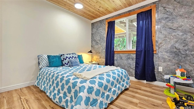 bedroom with baseboards, ornamental molding, wood finished floors, and wooden ceiling
