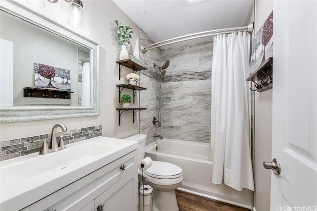 bathroom with vanity, toilet, wood finished floors, shower / tub combo, and decorative backsplash