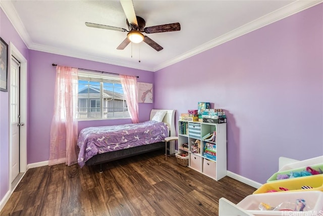 bedroom with crown molding, wood finished floors, ceiling fan, and baseboards