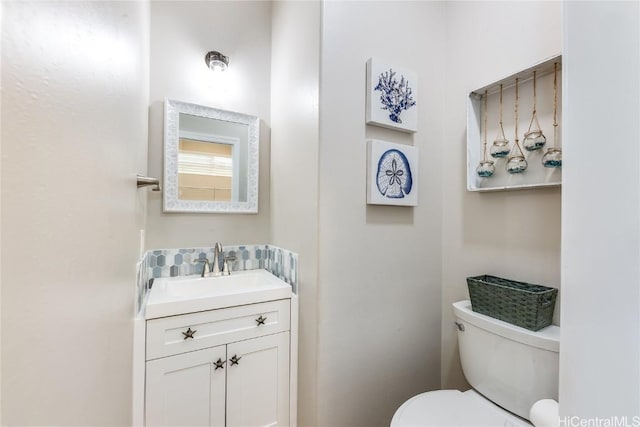 bathroom with toilet and vanity