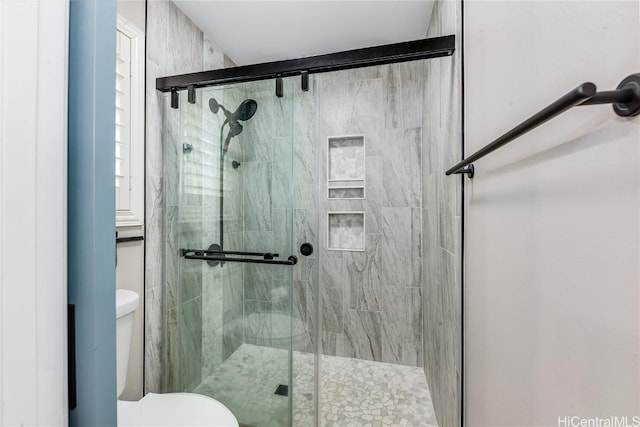 full bathroom featuring toilet and a stall shower