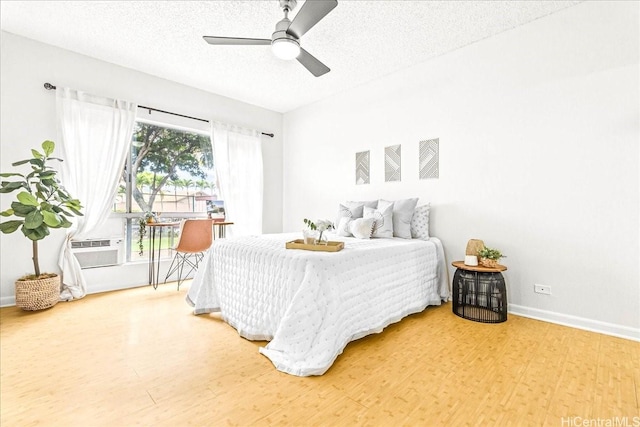 91-490 Puamaeole St Unit 46C, Ewa Beach, HI 96706 - bedroom with wood finished floors, a textured ceiling, baseboards, and ceiling fan