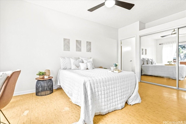91-490 Puamaeole St Unit 46C, Ewa Beach, HI 96706 - bedroom with wood finished floors, ceiling fan, a closet, baseboards, and a textured ceiling