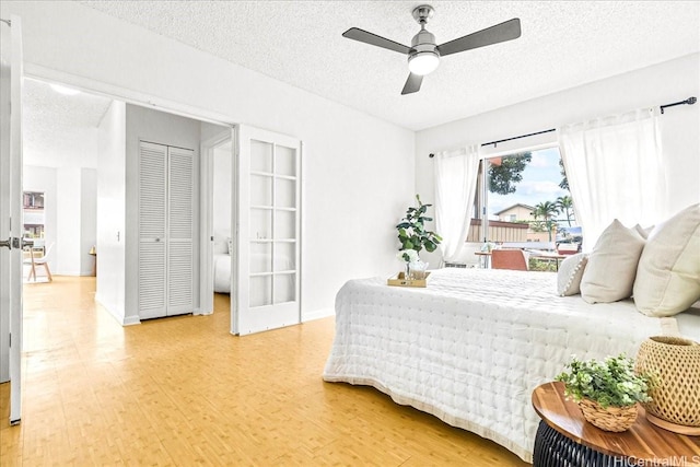 91-490 Puamaeole St Unit 46C, Ewa Beach, HI 96706 - bedroom with a textured ceiling, light wood finished floors, baseboards, and a ceiling fan