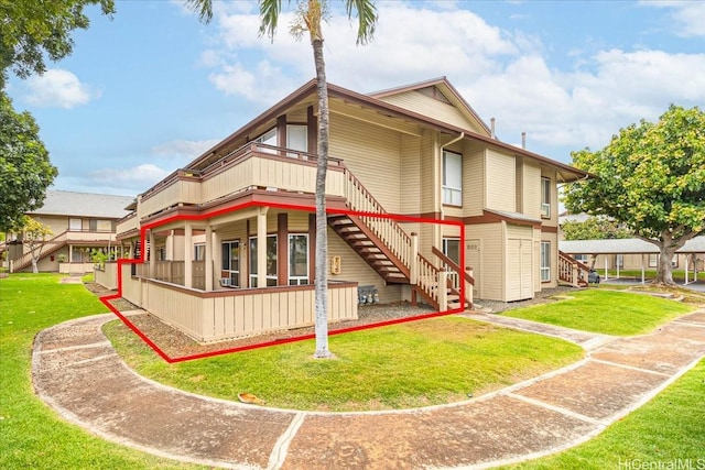 91-490 Puamaeole St Unit 46C, Ewa Beach, HI 96706 - back of property featuring stairway, a lawn, and a deck