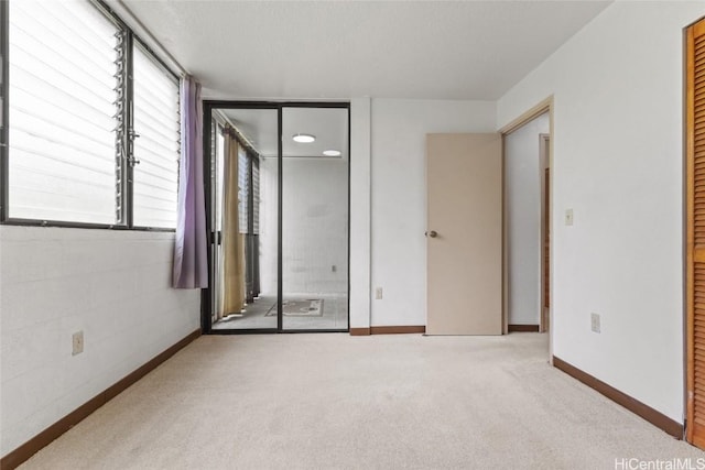 unfurnished bedroom with carpet flooring and baseboards