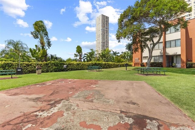 view of property's community with a lawn