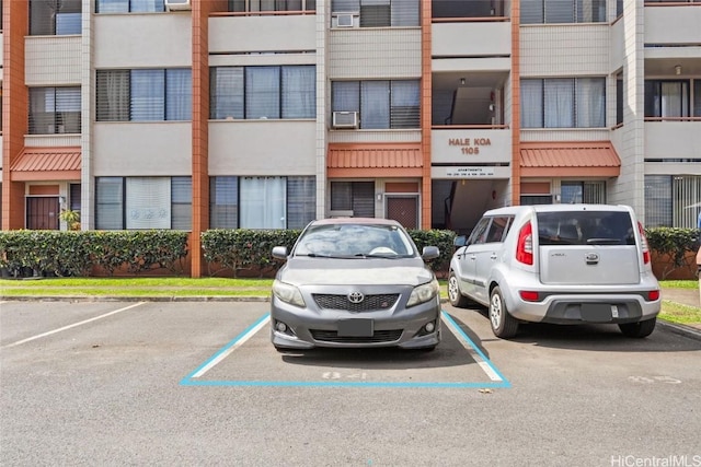 view of property featuring uncovered parking