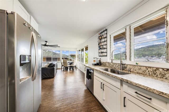 1924 10th Ave, Honolulu, HI 96816 - kitchen with stainless steel appliances, a sink, dark wood finished floors, and light stone countertops