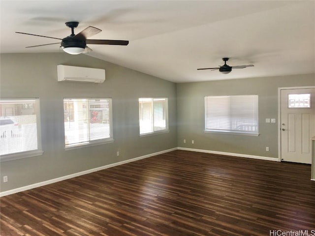unfurnished living room with wood finished floors, a wall unit AC, and ceiling fan