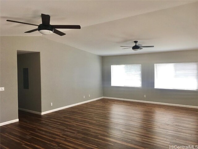 unfurnished room featuring dark wood-style floors, baseboards, vaulted ceiling, and ceiling fan