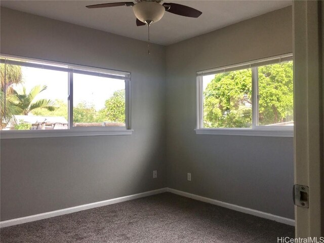 carpeted empty room with baseboards and ceiling fan