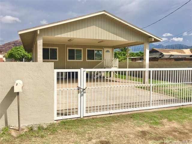 view of front of property featuring a gate and fence
