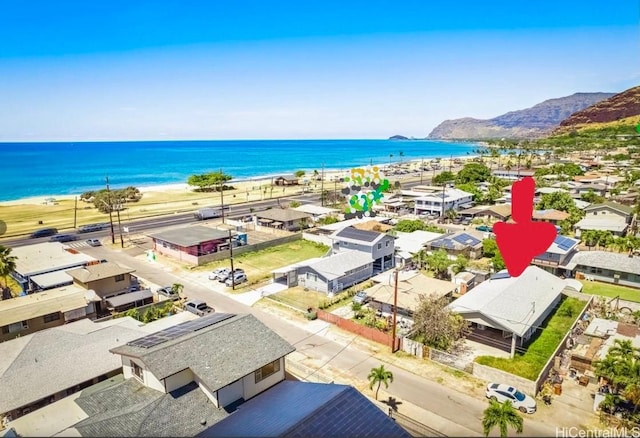 aerial view with a water view and a view of the beach