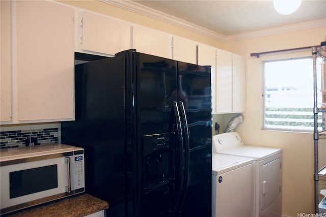kitchen with white microwave, crown molding, black refrigerator with ice dispenser, decorative backsplash, and washing machine and clothes dryer