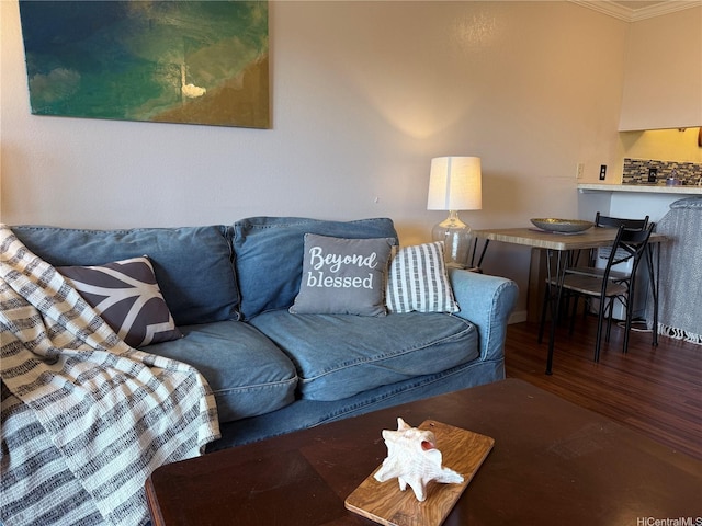 living room with crown molding and wood finished floors