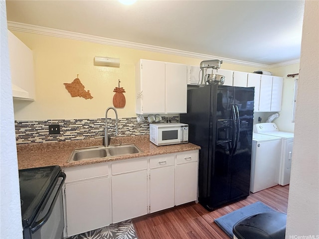 kitchen with dark wood-style flooring, a sink, crown molding, independent washer and dryer, and black appliances