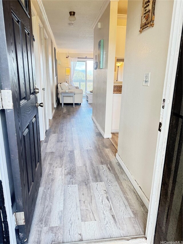 94-637 Kahakea St Unit 3I, Waipahu, HI 96797 - corridor with crown molding, wood finished floors, and baseboards