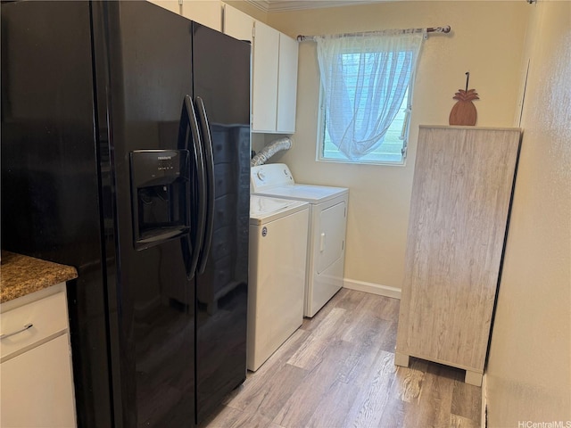 94-637 Kahakea St Unit 3I, Waipahu, HI 96797 - laundry area with light wood-type flooring, washing machine and clothes dryer, baseboards, and cabinet space