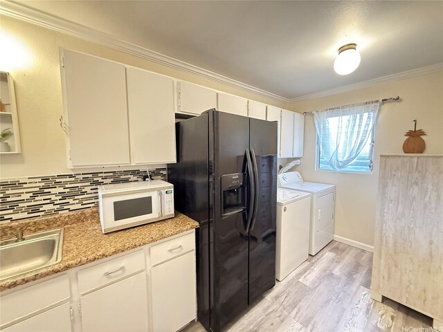 94-637 Kahakea St Unit 3I, Waipahu, HI 96797 - kitchen with white microwave, black fridge, independent washer and dryer, decorative backsplash, and crown molding