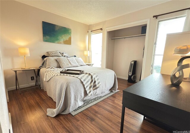 94-637 Kahakea St Unit 3I, Waipahu, HI 96797 - bedroom with a closet, wood finished floors, baseboards, and a textured ceiling